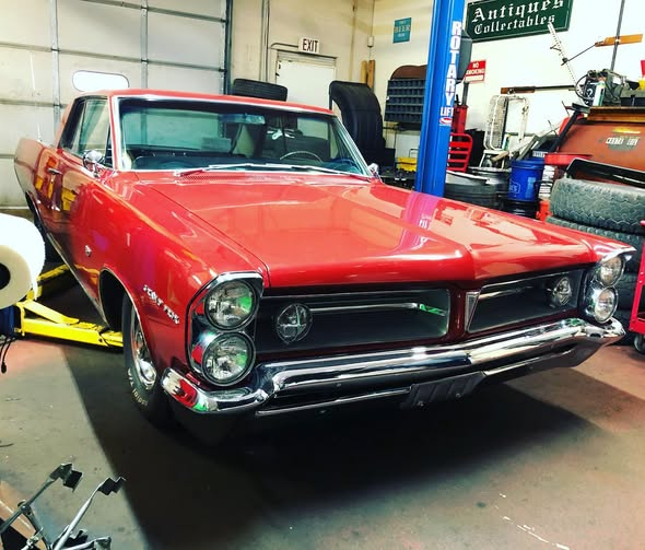 Restored red 1963 Pontiac Grand Prix in the shop