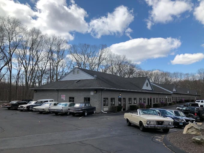 Rich & Ray's Automotive shop in Clinton, CT with classic cars parked out front