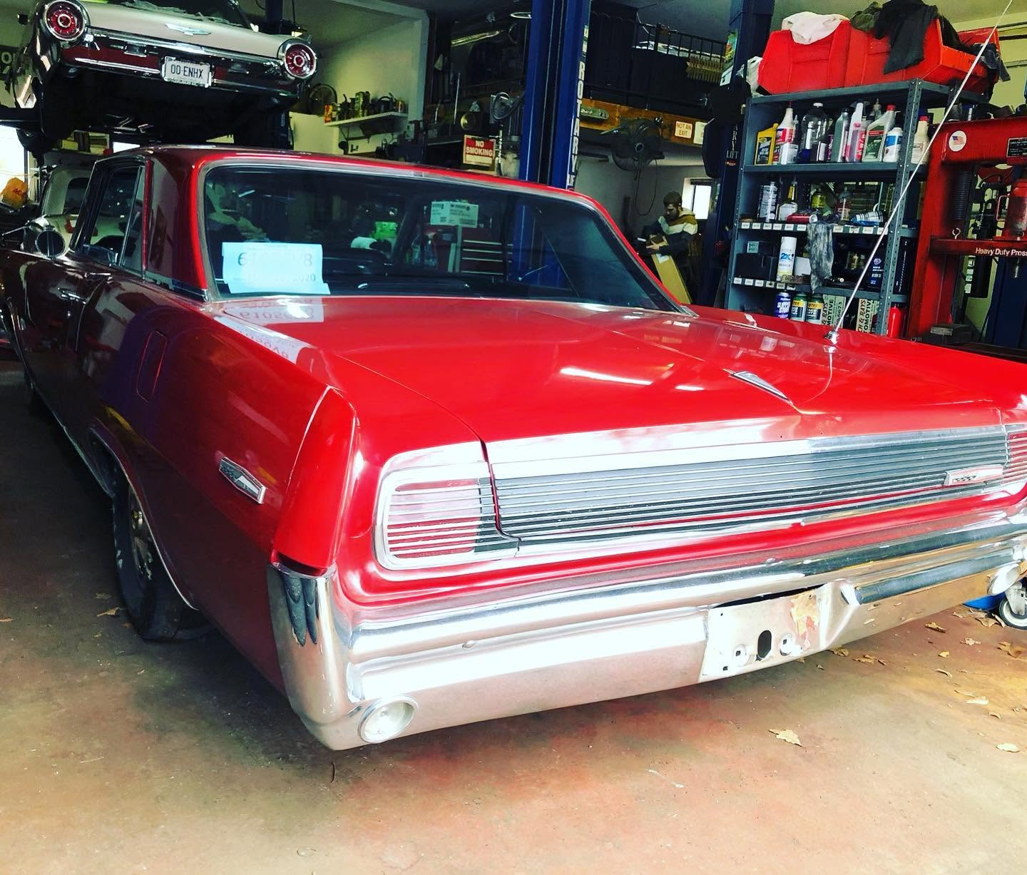 Restored red 1963 Pontiac Grand Prix in the shop